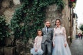 A happy young family walks through the old town of Sirmione in Italy.Stylish family in Italy on a walk Royalty Free Stock Photo