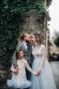 A happy young family walks through the old town of Sirmione in Italy.Stylish family in Italy on a walk Royalty Free Stock Photo