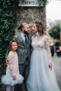 A happy young family walks through the old town of Sirmione in Italy.Stylish family in Italy on a walk Royalty Free Stock Photo