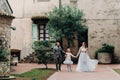 A happy young family walks through the old town of Sirmione in Italy.Stylish family in Italy on a walk Royalty Free Stock Photo