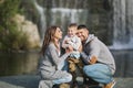 A happy young family on a waterfall background Royalty Free Stock Photo