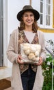 Young smiling woman holding grown medium with lion mane mushrooms Royalty Free Stock Photo