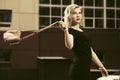 Happy young fashion blond woman in black dress walking in city street Royalty Free Stock Photo