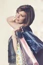 Happy young fashion woman with shopping bags walking in city street Royalty Free Stock Photo