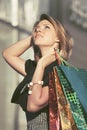 Happy young fashion woman with shopping bags walking at the mall Royalty Free Stock Photo