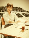 Happy young fashion business woman working at sidewalk cafe Royalty Free Stock Photo