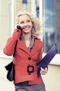 Happy young fashion businesswoman calling on cell phone Royalty Free Stock Photo