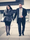 Happy young fashion couple in love walking on city street Royalty Free Stock Photo