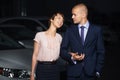 Happy young fashion couple in love walking on the city street at night Royalty Free Stock Photo