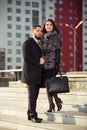 Happy young fashion couple walking on city street Royalty Free Stock Photo