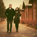 Happy young fashion couple walking next to cottage