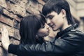 Happy young fashion couple in leather jackets at the brick wall Royalty Free Stock Photo