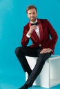 Happy young fashion man wearing red velvet tuxedo Royalty Free Stock Photo