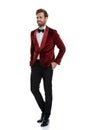 Happy young fashion model smiling and wearing red velvet tuxedo Royalty Free Stock Photo