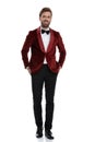 Happy young fashion model smiling and wearing red velvet tuxedo Royalty Free Stock Photo