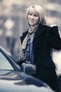 Happy young fashion woman with shopping bags next to her car Royalty Free Stock Photo