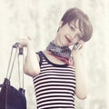 Happy young fashion woman with handbag calling on mobile phone Royalty Free Stock Photo