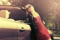 Happy young fashion woman leaning on her convertible car Royalty Free Stock Photo
