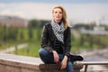 Happy young fashion woman in leather jacket and silk scarf Royalty Free Stock Photo