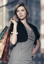 Happy young fashion woman with shopping bags at the mall Royalty Free Stock Photo