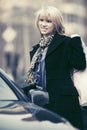 Happy young fashion woman with shopping bags next to her car Royalty Free Stock Photo