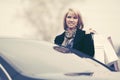 Happy young fashion woman with shopping bags next to her car Royalty Free Stock Photo