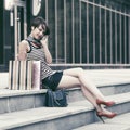 Happy young fashion woman with shopping bags talking on cell phone Royalty Free Stock Photo