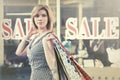 Happy young fashion woman with shopping bags walking in the mall Royalty Free Stock Photo