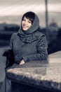 Happy young fashion woman in classic coat and head scarf Royalty Free Stock Photo