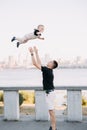 Happy young father has fun, plays with his toddler boy and tosses up him Royalty Free Stock Photo