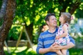 Happy young father having fun cute toddler daughter, family portrait together. man with beautiful baby girl in summer Royalty Free Stock Photo