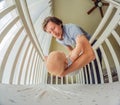 Happy young father putting his smiling baby in a white crib next to a window Royalty Free Stock Photo