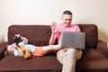 Happy young father sit on computer using laptop with son having a video call. Smiling dad sitting and little boy child Royalty Free Stock Photo