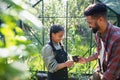 Happy young father with small daughter working outdoors in backyard, gardening and greenhouse concept. Royalty Free Stock Photo