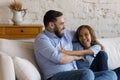 Happy young father tickling preteen son at home. Royalty Free Stock Photo