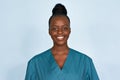 Happy young female african scrub nurse wear blue uniform isolated on background. Royalty Free Stock Photo
