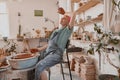 Caucasian craftswoman making bowl in pottery workshop