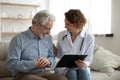 Happy doctor sharing good test results news with old patient. Royalty Free Stock Photo