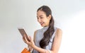 Happy young female holding shopping bags and mobile phone. Asian woman use of mobile phone and holding shopping bag. Female Royalty Free Stock Photo