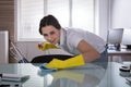 Happy Female Janitor Cleaning Desk With Rag Royalty Free Stock Photo