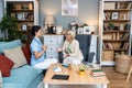 Happy young female nurse provide care medical service help support smiling old grandma at homecare medical visit, lady carer Royalty Free Stock Photo