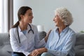 Happy young female nurse provide medical service support old grandma Royalty Free Stock Photo