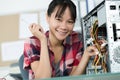 Happy young female pc technician in class Royalty Free Stock Photo