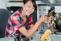 Happy young female pc technician in office Royalty Free Stock Photo