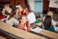 Happy young female redhead student in amphitheater