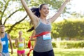 Happy young female runner winning on race finish