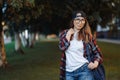 Happy Young female student dressed in casual clothing with backpack behind her back walking around city. Summer sunset Royalty Free Stock Photo