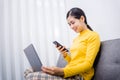 Happy young female surfing the internet shopping online at home after the government announced a ban on leaving the house.,