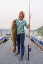 Happy Fisherwoman holding big arctic cod. Norway happy fishing. Woman with cod fish in hands Royalty Free Stock Photo