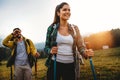 Happy young fit couple hiking, trekking outdoors